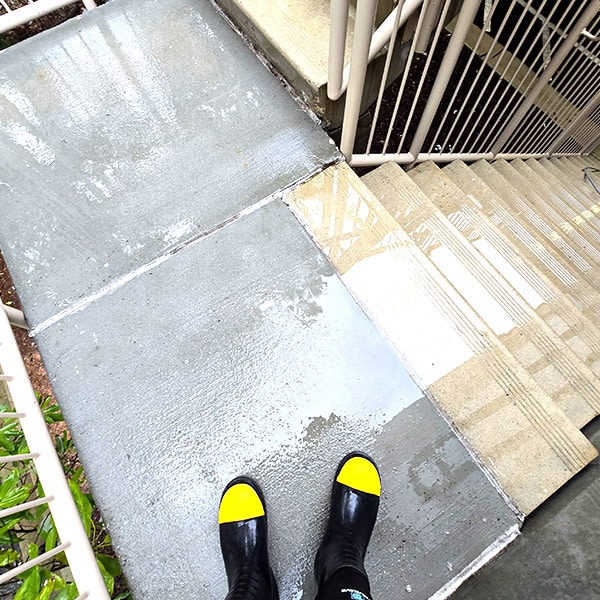 Clean concrete walkway after pressure washing